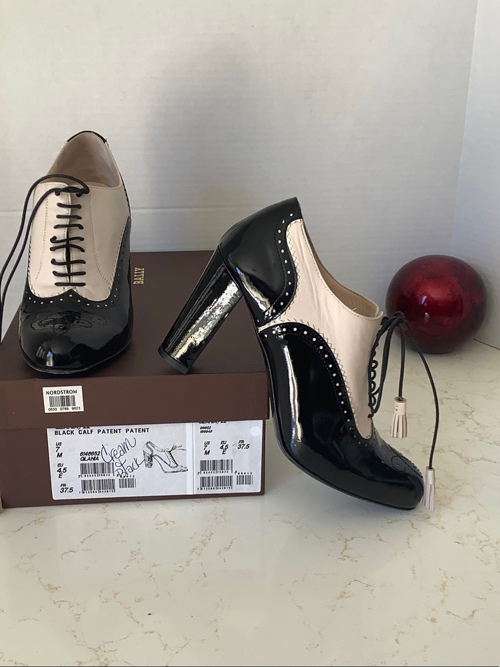 Bally Two-Tone Patent Leather Brogue Pumps in Black & Cream